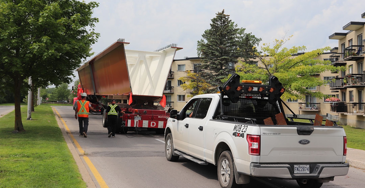 As can be seen in these images, the box girders were painted orange to match the old railway bridge.