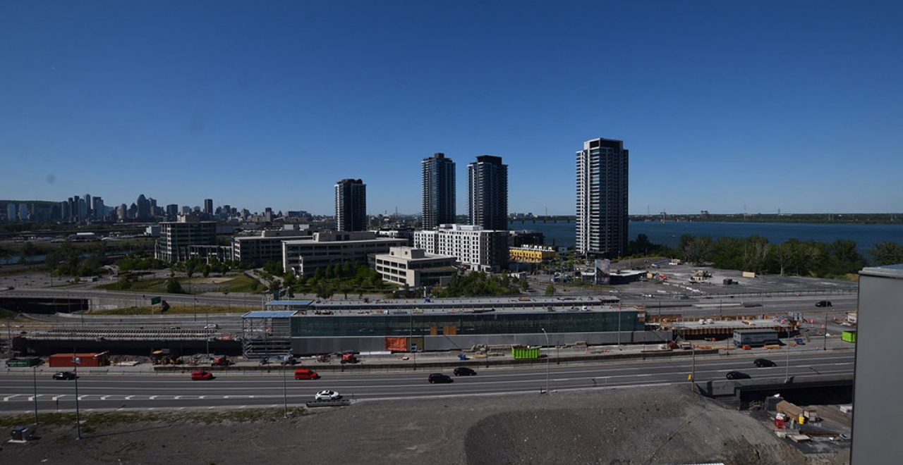 Continuing along the central segment of the REM, the Île-des-Sœurs station is taking shape. The station’s steel skeleton is completed and the installation of the curtain walls has begun. The interior fit-out will be initiated in 2021. | Île-des-Sœurs Station - May 2021